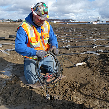 Coiling cable after pipe cut off at grade