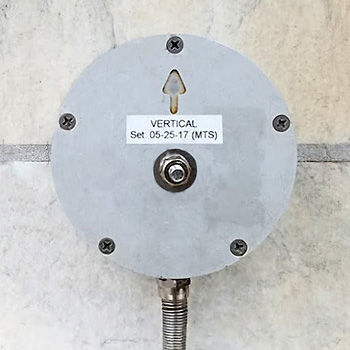 vertical triaxial geophone anchored to wall